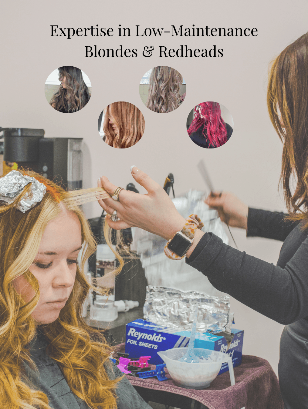 A hairstylist working on a woman's hair in a salon, with hair color samples above and hair tools on the counter.