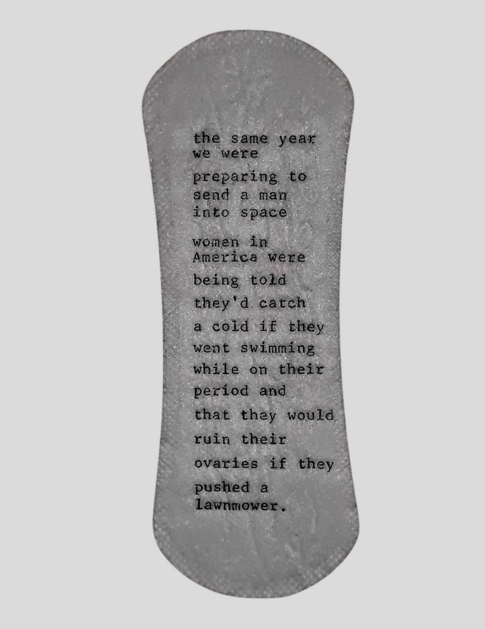Text on a gray, oval-shaped surface with a rough texture, discussing space, women, and reproductive rights.