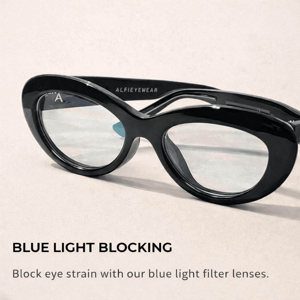 Black cat-eye glasses with clear lenses on a light background, beside text advertising blue light blocking lenses.